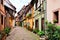 Colorful street in Eguisheim, France with timbered houses