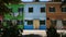 Colorful street with multicolored houses, laundry drying in wind, green plants