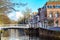 Colorful street view with houses and canal in Delft, Holland