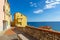 Colorful streets of mediterranian town with deep blue sky and se