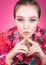 Colorful Studio portrait of a beautiful young woman in bright pink clothes