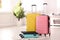 Colorful suitcases packed for journey in bedroom.