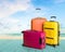 Colorful suitcases stack on beach background