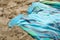 Colorful summer beachwear . towel on sand beach.