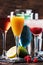 Colorful summer cocktails. Cold alcoholic beverages and drinks: mimosa, cosmopolitan, raspberry margarita and blue hawaii on