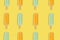 Colorful summer pattern. Mango and lemon popsicles on a yellow background