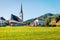 Colorful summer scene of Pfarramt Catholic Church. Bright morning view of the Gosau village in the district of Gmunden in Upper