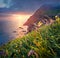 Colorful summer scene from Sunset Viewpoint in Gasadalur village. Dramatic evening landscape of Vagar island. Fantastic seascape o