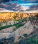 Colorful summer sunset in Cappadocia. Picturesque evening view of Red Rose valley. Cavusin village located, district of Nevsehir P