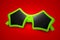 Colorful sunglasses with star shape on red background. Complementary color