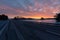 Colorful sunrise with clouds in the sky and frozen lake