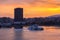 Colorful sunrise with fiery sky over the port and the city of Piraeus