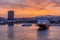 Colorful sunrise with fiery sky over the port and the city of Piraeus. Passenger vessels docked at the jetty