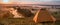 Colorful sunrise over tourist tent in camp among meadow