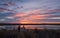 Colorful sunrise reflection on a lake with a fishing dock