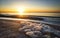 Colorful sunrise on the sea, sea foam on the shore