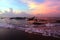 Colorful sunrise sky with cloud background on the beach. With traditional fishing boat on sea and fishermen at work