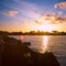 Colorful sunrise on the Tuscan coast in winter with the sun reflecting on the clouds and sea, shot with analogue film technique