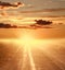 Colorful sunset over country road on dramatic sky