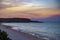 Colorful sunset and peaceful ocean wave at the beach.