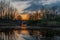 Colorful sunset and reflections in the water at the railway bridge in the Frontenpark in Maastricht.