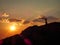 Colorful sunset with silhouette of a girl with scarf flying on the wind