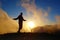 Colorful sunset with a silhouette of a relaxed teenage boy on a long distance hiking trail GR131 leading from Fuencaliente to Taza