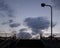 Colorful sunset sky above a pedestrian overpass. Contrastive dusk view.