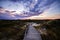 Colorful sunset view of wooden touristic walkway in nature reserve