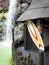 Colorful surfboard and typical Hawaiian hut.