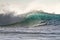 Colorful Surfing Wave Lit with sunlight in Pacific Ocean