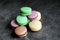 Colorful and sweet macaroon cookies on dark background