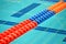 Colorful swimming pool line separator on water, sport diversity,