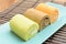 Colorful swiss roll on green dish
