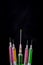 Colorful syringe on dark background