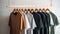 Colorful t-shirts hanging on wooden hanger on grey wall