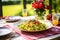 colorful table setting with a spelt pasta with pesto dish