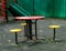 Colorful table and stools and a children`s slide on the Playground