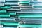 Colorful teal metallic tube as texture. Iridescent wallpaper. Metal surface, trendy design. Abstract background