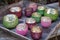 Colorful tealight candle holders on a tray