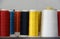 Colorful thread in the thread roll, yellow color, red, white, blue, orange and dark blue.