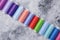 Colorful threads  bobbins, sewing set.On gray concrete background. Place for text