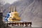 Colorful three stupa or chedi in Maitreya Buddha statue and Diskit Monastery perched against the hills at nubra valley village