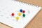 Colorful thumbtack, pushpin or pins on calendar concept for busy meeting schedule, reminder or special event and important