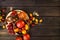 Colorful tomatoes on wooden background. top view. dark wood table