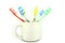 Colorful Toothbrushes In A White Mug