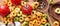 Colorful tortellini pasta, tomatoes and garlic on wooden table, banner