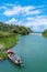 Colorful Tour Boat/Fishing Boat in scenic tropical landscape