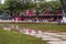 Colorful tour train in the park with wetland grass