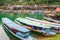 Colorful tourist boats on Nam Ngum Lake, Pier, raft, and floating house background. Top tourist attractions in Laos. Vientiane Pr